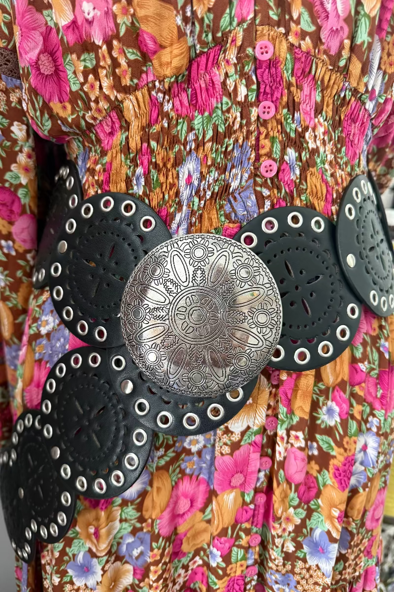 boho belt with black and silver design on a colorful floral background
