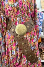 boho belt on a colorful floral dress with a blurred background